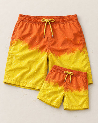 Dad & Mini matching swim shorts in Orange to Yellow, splashed with water so both colours show