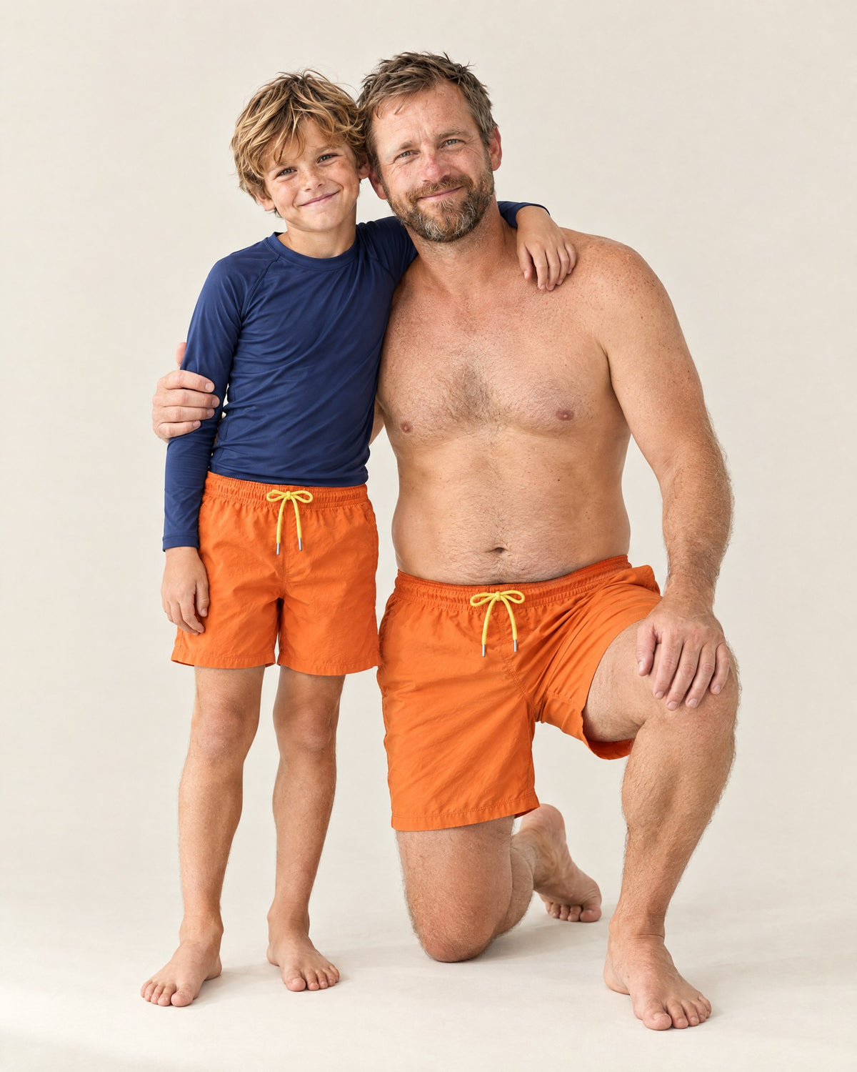 Dad and son wearing the Orange to Yellow Dad & Mini set, dry