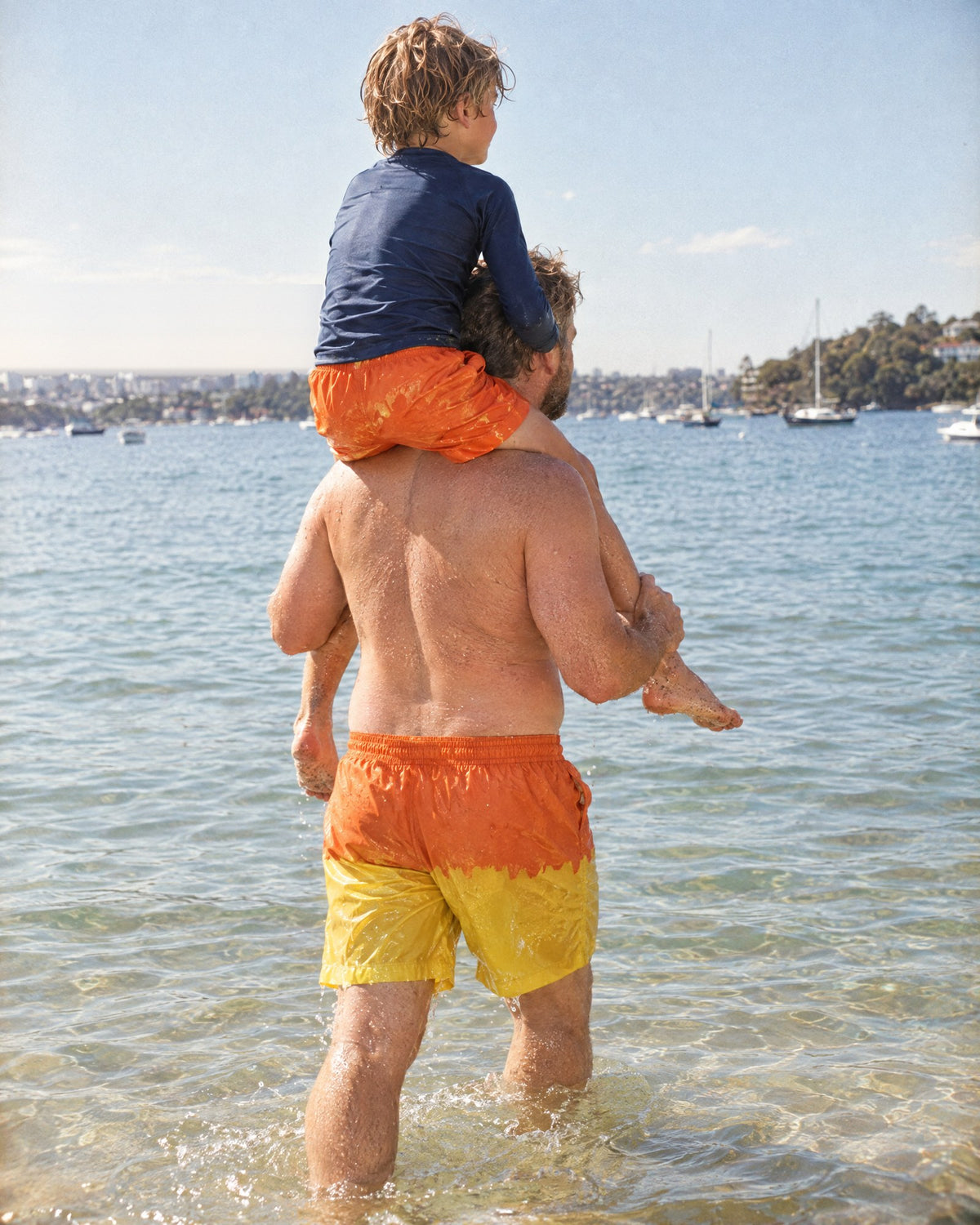 Dad and son in the Orange to Yellow Dad & Mini set, yellow where they got wet