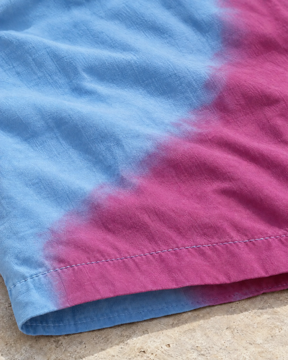 Close-up of Shift Purple to Blue swim shorts showing the colour change at the hem
