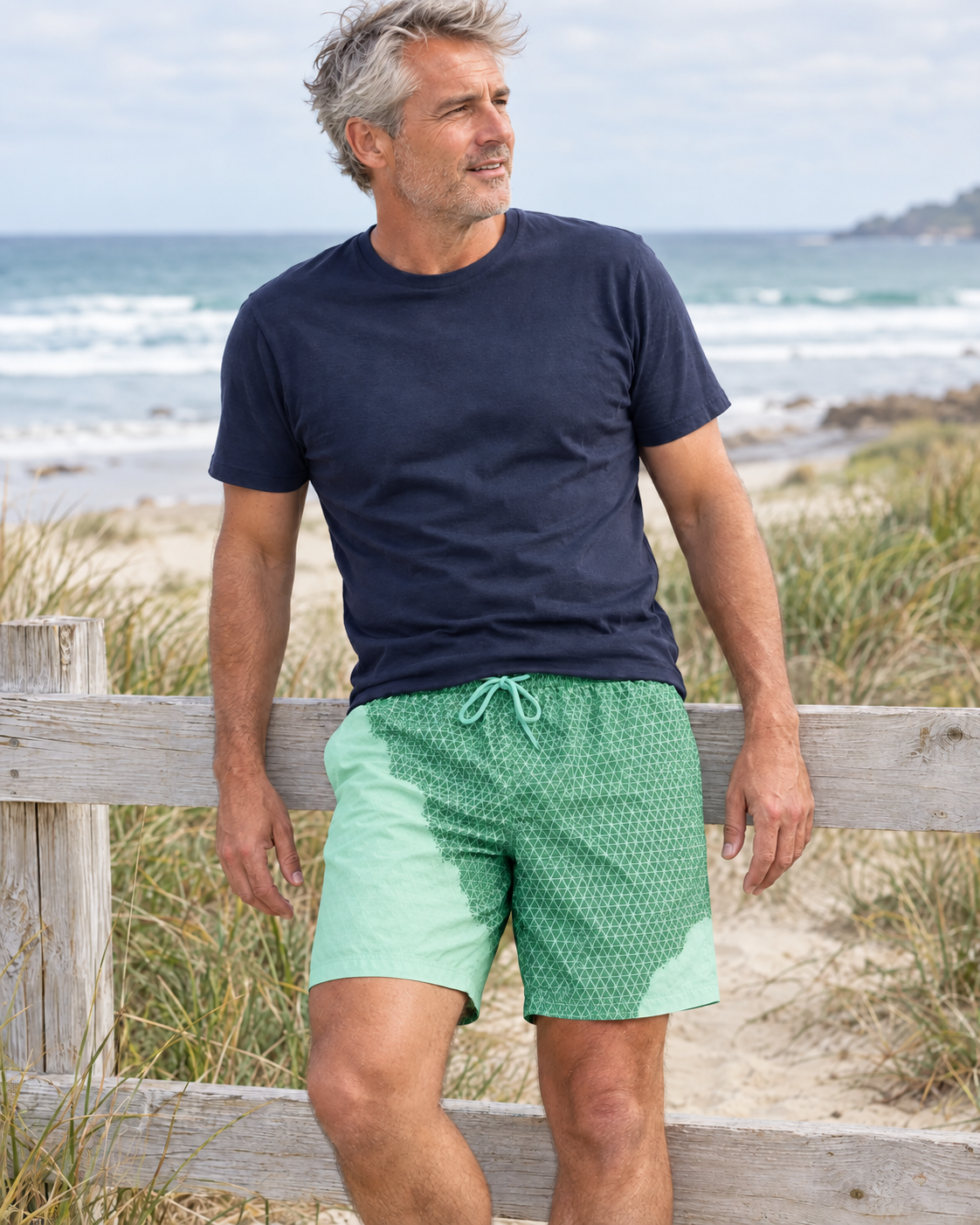 Man at the beach in Shift Geometric Green to Mint swim shorts