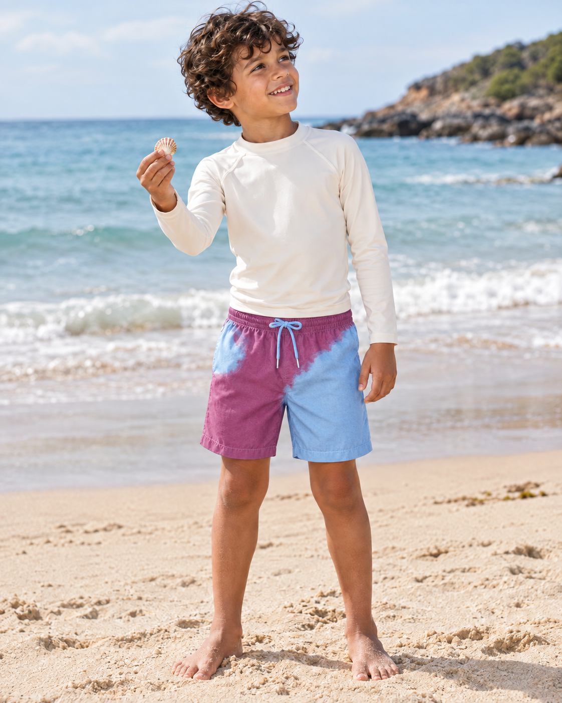 Boy on the beach in Shift kids Purple to Blue swim shorts