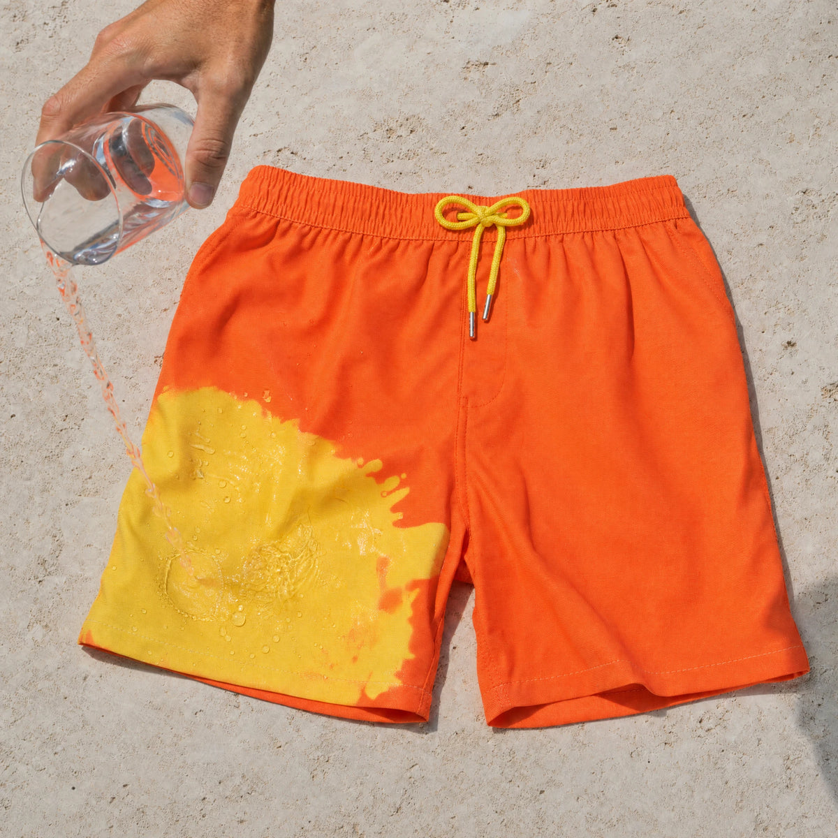 Warm water turning Shift Orange to Yellow swim shorts yellow where it lands