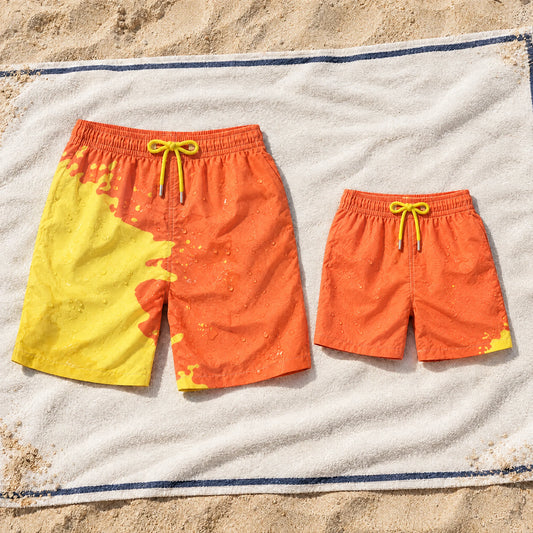 Shift Dad & Mini matching set in Orange to Yellow on a beach towel