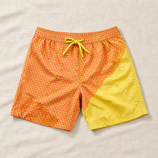 Shift Geometric Orange to Yellow swim shorts on linen, showing both colours