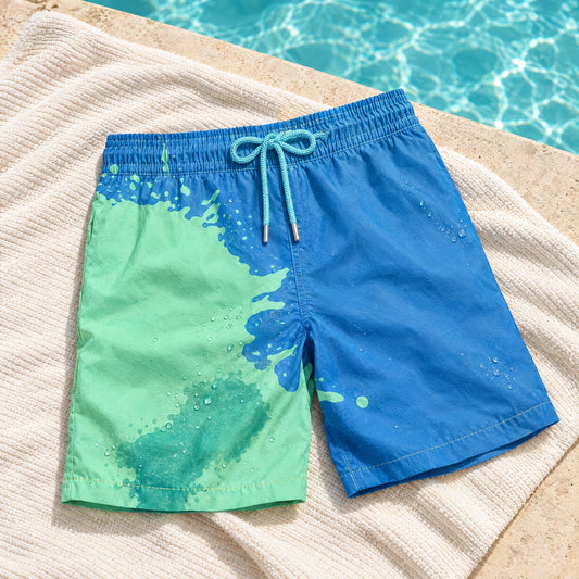Shift Blue to Green swim shorts on a poolside towel, showing both colours